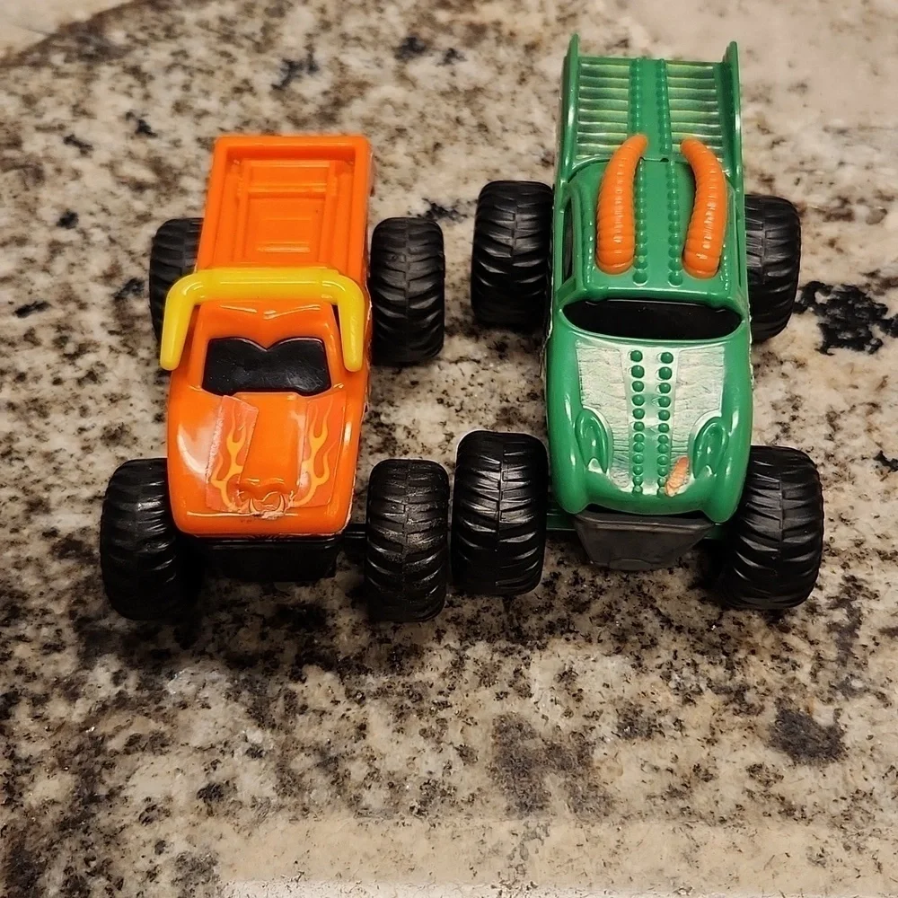 Monster jam plastic Rev up trucks has paper stickers ripping 2 cars